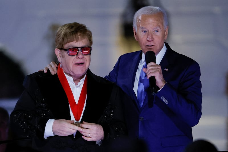 Mr Biden lauded Sir Elton for his charitable work with the Elton John Aids Foundation. Reuters