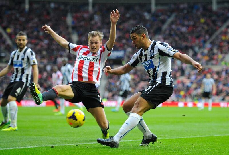 Newcastle's Hatem Ben Arfa, right, crossing under pressure from Sebastian Larsson of Sunderland. The hosts defeated Newcastle 2-1 on Sunday to move off the foot of the table.  Stu Forster / Getty Images