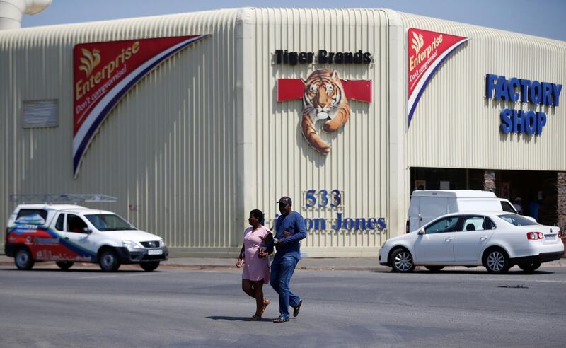 FILE PHOTO: A couple leaves Tiger Brands factory shop in Germiston, Johannesburg, South Africa, March 5, 2018. REUTERS/Siphiwe Sibeko/File Photo