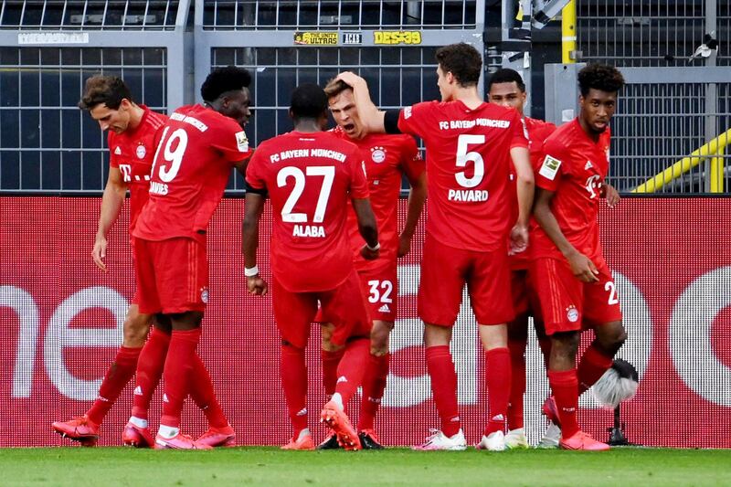 Soccer Football - Bundesliga - Borussia Dortmund v Bayern Munich - Signal Iduna Park, Dortmund, Germany - May 26, 2020 Bayern Munich's Joshua Kimmich celebrates scoring their first goal with teammates, as play resumes behind closed doors following the outbreak of the coronavirus disease (COVID-19) Federico Gambarini/Pool via REUTERS  DFL regulations prohibit any use of photographs as image sequences and/or quasi-video