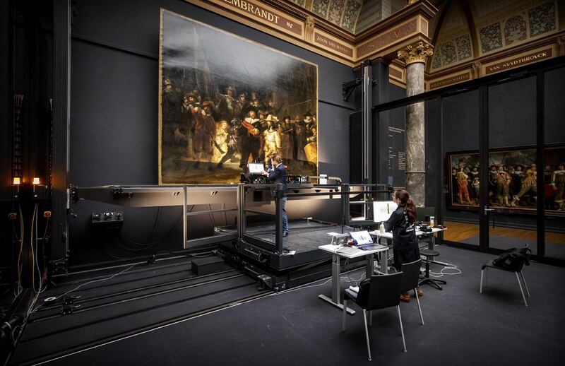 Restorers at work in front of Rembrandt van Rijn's 'The Night Watch' at the Rijksmuseum (National Museum) in Amsterdam. Only two researchers can work on the masterpiece at the same time due to new safety measures.  EPA