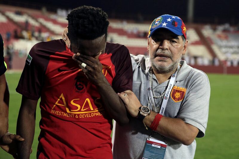 Soccer Football - Al Fujairah v Khor Fakkan - UAE First Division - Fujairah stadium, Fujairah, United Arab Emirates - April 27, 2018 - Al Fujairah's manager Diego Maradona consoles a player after a draw against Khor Fakkan and missing out the automatic promotion to the Arabian Gulf League. REUTERS/Christopher Pike