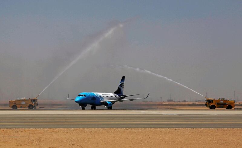 An EgyptAir plane arrives to a water cannon salute on the runway of the Capital International Airport, a new airport built for Egypt's New Administrative Capital, east of Cairo.  Reuters