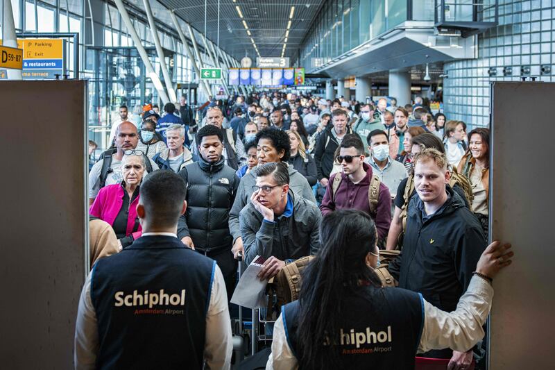 Travellers wait in a departure hall at Schiphol airport, near Amsterdam, a day after a strike by KLM luggage handlers which caused many flights to be cancelled. AFP