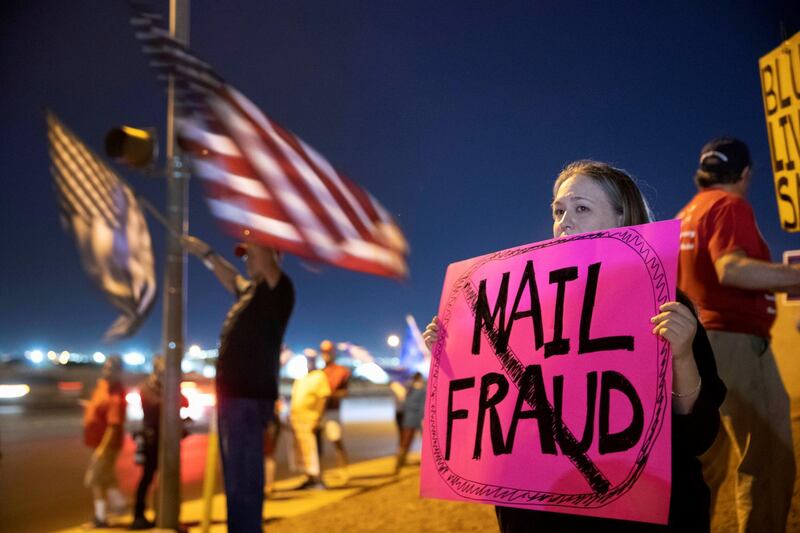 Meg Ross, a supporter of President Donald Trump, holds a sign during a 'Stop the Steal' protest at the Clark County Election Centre in Las Vegas, Nevada. Reuters