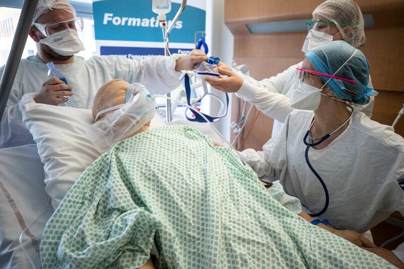 A doctor teaches on a mannequin how to treat a coronavirus patient during a training session for nurses at the Nouvel Hopital Civil of Strasbourg, eastern Franc. AP