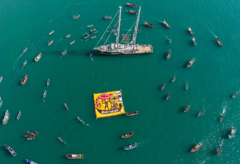Boats circle the Rainbow Warrior during a protest against a coal-fired project in the Gulf of Thailand near Songkhla province. Arnaud Vittet / EPA