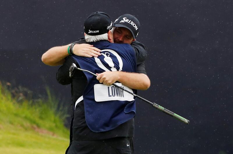 Lowry celebrates with his caddie after winning The Open Championship. Reuters