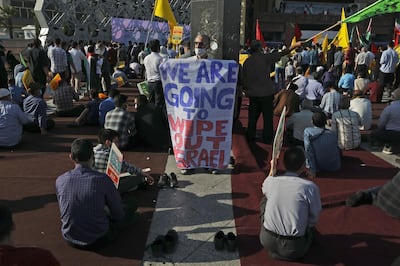 A demonstrator holds an anti-Israeli placard in a pro-Palestinians gathering in Tehran, Iran, Wednesday, May 19, 2021. Chief of the powerful Revolutionary Guard Gen. Hossein Salami said in the gathering that Israel has become weaker and the Palestinians have become stronger and more powerful. Iran does not recognize Israel and supports anti-Israeli militant groups like Palestinian Hamas and Lebanon's Hezbollah. (AP Photo/Vahid Salemi)