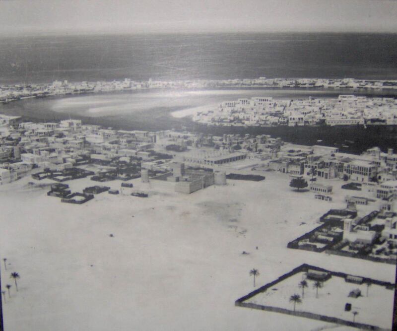 Dubai in 1950. Al Fahidi Fort in Bur Dubai is in the foreground, with Deira in the middle-right on the other side of the creek. Al Shindagha (L) and Al Ras (R) are in the background across the creek from Deira.