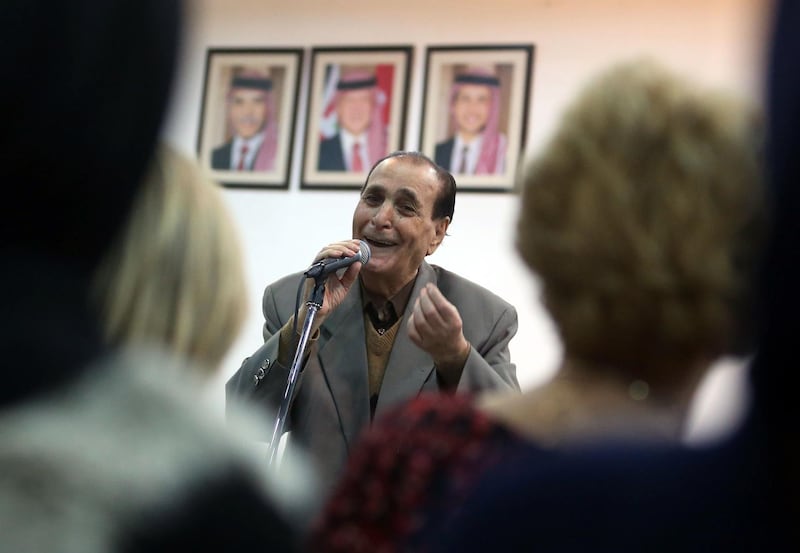 Jordanian singer Mohamed Wahib sings with the Beit al-Rowwad ensemble during a concert at Hussein Cultural Center in Amman on March 13, 2018. Beit al-Rowwad (The House of Pioneers), a group of musicians founded in 2008 with all its members aged 50 and above, has caused a sensation in Jordan by reviving the golden era of Arab song, represented by Ghazali and Egyptian superstar Umm Kulthoum as well as local folklore songs. / AFP / Khalil MAZRAAWI
