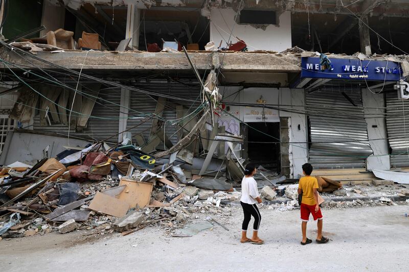 Children check the damage cause by an Israeli strike on a cafe in Khan Yunis in the southern Gaza Strip. AFP