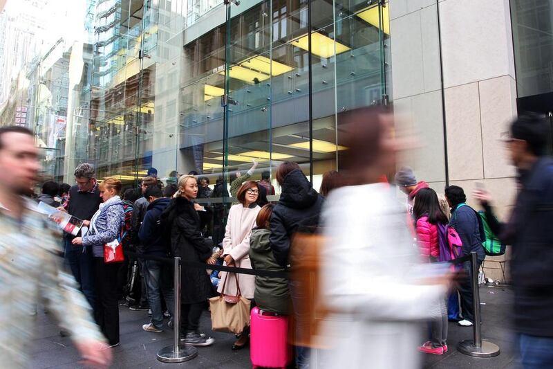 Customers wait in line outside the Apple Inc George Street store in Sydney. Lisa Maree Williams / Bloomberg