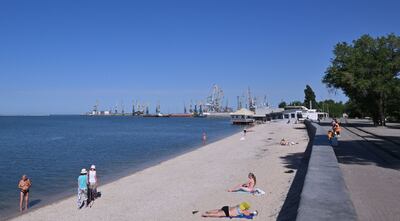 The Russian port of Berdyansk, with people sunbathing on the beach nearby. AFP