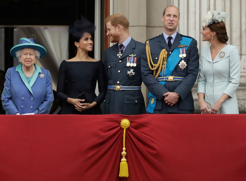 Britain's Queen Elizabeth II, Meghan the Duchess of Sussex, Prince Harry, and the Prince and Princess of Wales watch a flypast over Buckingham Palace on July 10, 2018. AP