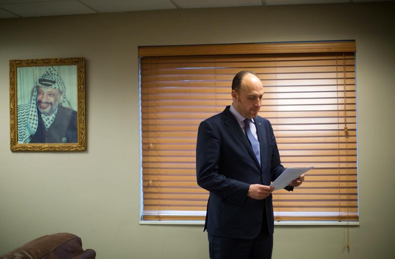 Husam Zomlot, the Palestinian envoy to Washington, reviews papers in Washington, Friday, Feb. 16, 2018. A few miles down the road from Israelâ€™s gated embassy, Zomlot sits in his office wrestling with a unique diplomatic dilemma: how to advance his peopleâ€™s cause at a time relations with the United States are so distant, he hasnâ€™t even spoken to the White House in months.(AP Photo/Pablo Martinez Monsivais)