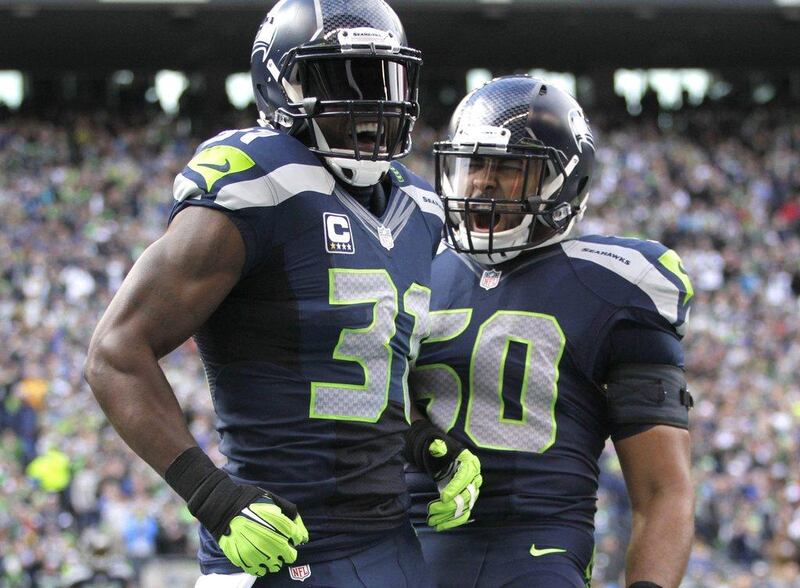 Seattle Seahawks' Kam Chancellor, left, and KJ Wright, right, celebrate during their team's NFL win against the St Louis Rams on Sunday. John Froschauer / AP / December 28, 2014  