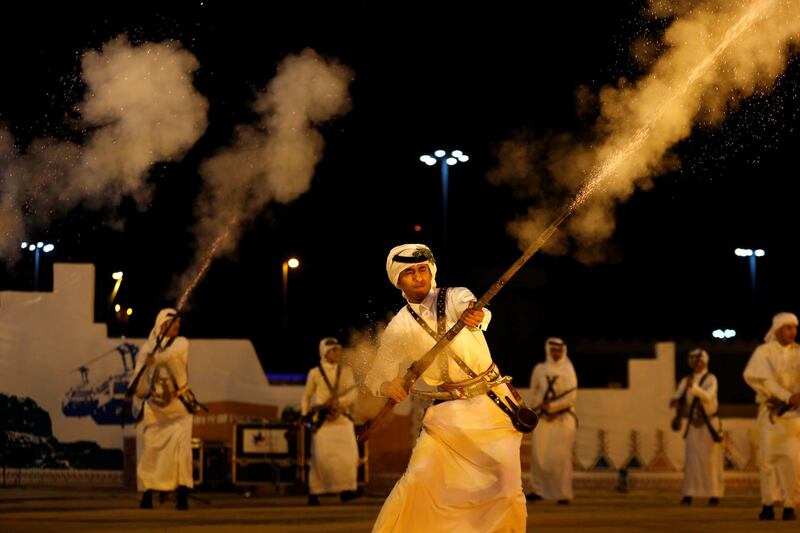 Saudi men fire weapons as they perform a traditional dance during Janadriyah Cultural Festival on the outskirts of Riyadh, Saudi Arabia. Reuters