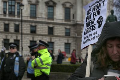 A protester holds a sign expressing their anti-government views in London, England. Getty Images