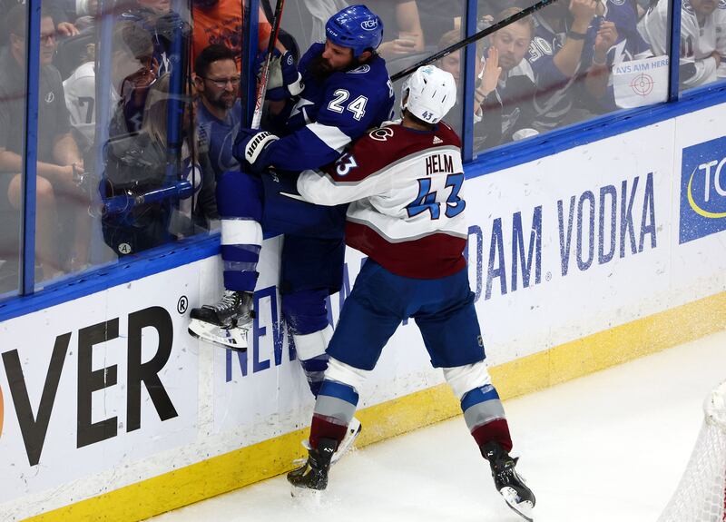 Colorado Avalanche centre Darren Helm (43) checks Tampa Bay Lightning defenseman Zach Bogosian (24) into the boards. Reuters