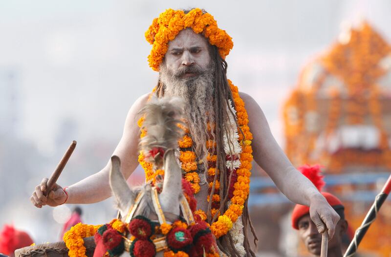 A Naga Sadhus, or Naked Hindu holy man, participate in a religious procession towards the Sangam, the confluence of rivers Ganges, Yamuna and mythical Saraswati, as part of the Mahakumbh festival in Allahabad, India, Saturday, Jan. 5, 2013. Millions of Hindu pilgrims are expected to take part in the large religious congregation on the banks of the Sangam during the festival in January 2013, which falls every 12th year. (AP Photo/Rajesh Kumar Singh) *** Local Caption ***  India Kumbh Festival.JPEG-0ea0d.jpg