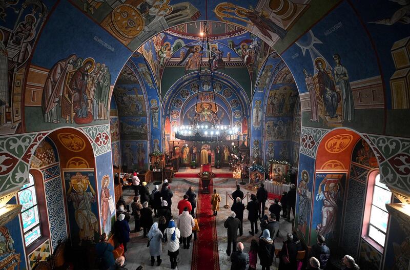 Members of the congregation listen during a service of the Nativity of Christ Liturgy at the Serbian Orthodox Church of the Holy Prince Lazar in Birmingham, on Friday. Orthodox Christians celebrate Christmas according to the Julian calendar, with Christmas Day falling on January 7. AFP