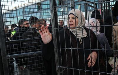 A Palestinian woman bids farewell to family member as they prepare to cross to Egypt through the Rafah border crossing in the southern Gaza Strip, on January 29, 2019. The sole passenger crossing between Gaza and Egypt was expected to reopen in both directions today, according to the Palestinian territory's ruling Hamas movement, after it was partially closed amid Palestinian political infighting. / AFP / SAID KHATIB
