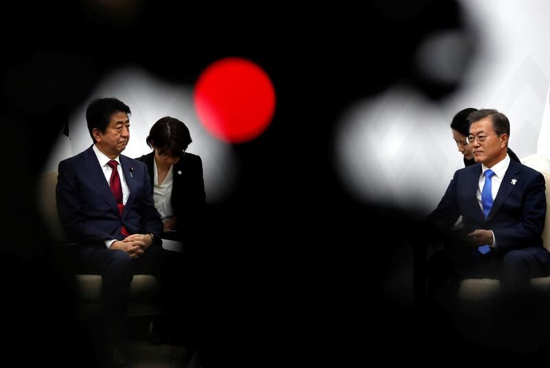 South Korean president Moon Jae-in talks with Japanese prime minister Shinzo Abe during their meeting in PyeongChang, South Korea. Kim Hong- Ji / EPA