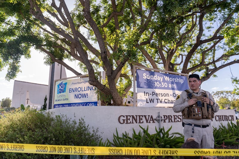 An Orange County Sheriff's Department officer guards the grounds of Geneva Presbyterian Church. AP