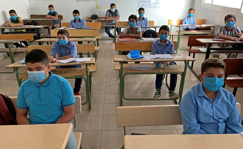 Students wearing protective face masks maintain social distancing as they attend a class after some schools reopened amid the coronavirus disease (COVID-19) crisis, in Misrata, Libya. REUTERS