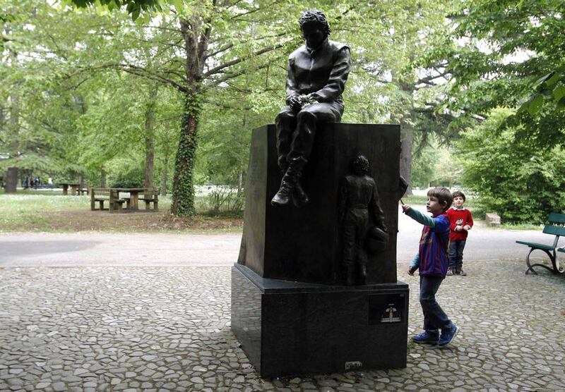 Children look at the memorial statue of Ayrton Senna erected at the park inside the race track at Imola. Alessandro Garofalo / Reuters / April 30, 2014