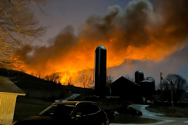 The fire is seen from Melissa Smith's farm in East Palestine. AP