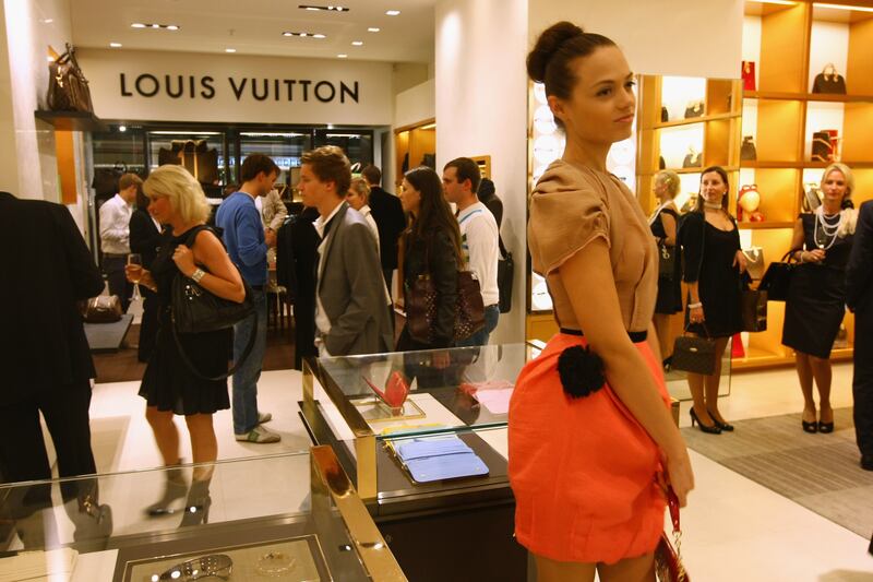 A model greets shoppers at the Louis Vuitton luxury store in Berlin, Germany, in 2009