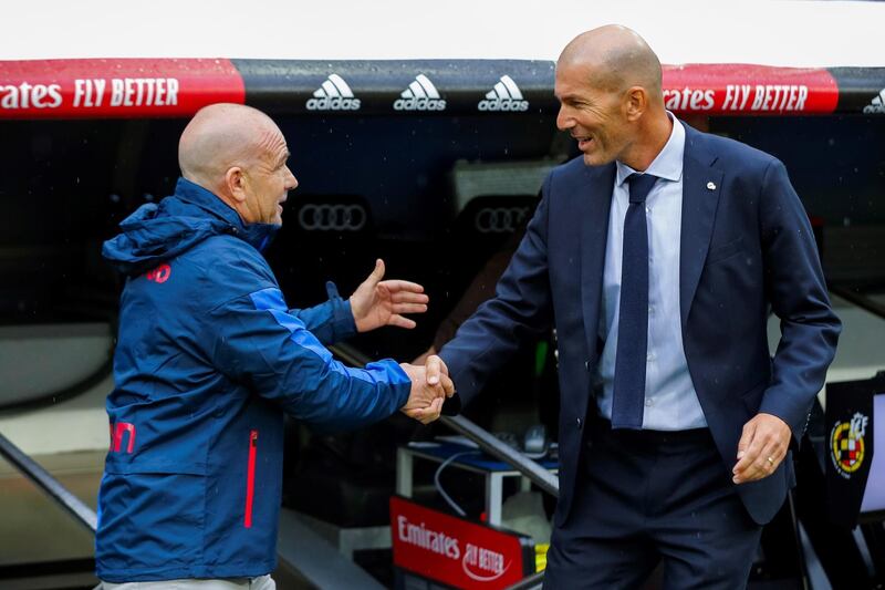 Real Madrid's head coach Zinedine Zidane, right, greets Levante's head coach Paco Lopez. EPA