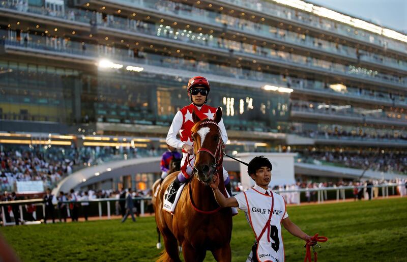 epa07473175 Jockey Yutaka Take of Japan on Matera Sky prepares to compete in the Dubai Golden Shaheen race during the Dubai World Cup 2019 at the Meydan race course in the Gulf emirate of Dubai, United Arab Emirates, 30 March 2019. The Dubai World Cup is one of the highest endowed events in the horse racing calendar.  EPA/ALI HAIDER