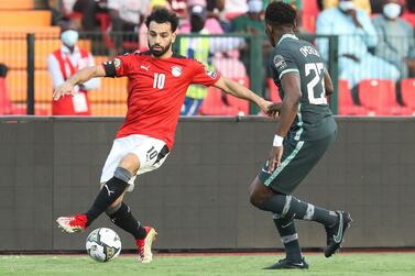 Egypt's Mohamed Salah in action in front of Nigeria's Kenneth Omeruo during the African Cup of Nations Group D soccer match between Egypt and Nigeria in Garoua, Cameroon, Tuesday, Jan.  11, 2022.  (AP Photo / Footografiia)