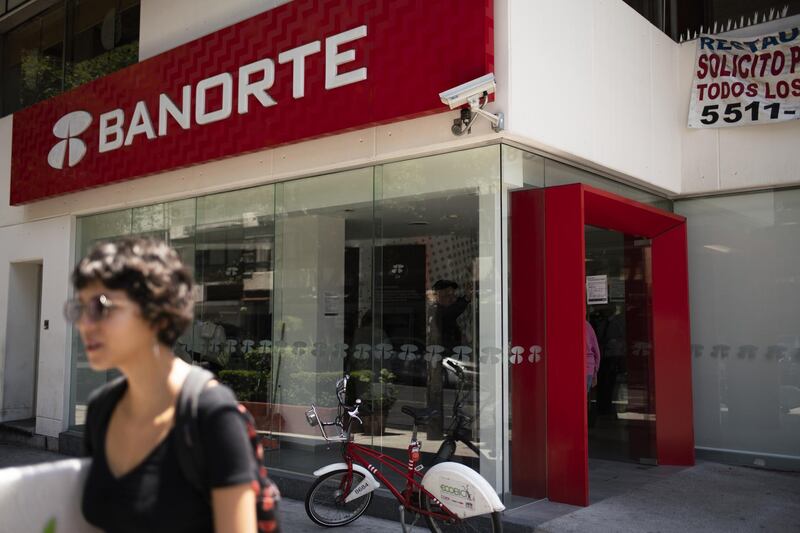 A pedestrian passes in front of a Grupo Financiero Banorte SAB bank branch in Mexico City, Mexico, on Tuesday, May 15, 2018. Several Mexican banks experienced large cash withdrawals in recent weeks after possible cyber attackers infiltrated some financial institutions, triggering unauthorized money transfers, the central bank said in an interview with Bloomberg. Photographer: Jonathan Levinson/Bloomberg