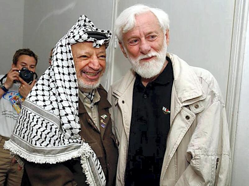This picture released by the Palestinian Authority shows Palestinian leader Yasser Arafat (L) posing with Uri Avnery, the head of Israeli peace group Gush Shalom, inside his battered compound in the West Bank city of Ramallah 08 May 2002. A group of 17 international peace activists, including five Israelis, moved into the compound to prevent what they fear is Israel's decision to kill Arafat. The Palestinian Authority evacuated its security and administrative offices fearing swift reprisals by the Israeli military for a suicide bombing that killed 17 people, including the kamikaze, outside Tel Aviv late yesterday.      AFP PHOTO/PPO/HO / AFP PHOTO / PPO / HUSSEIN HUSSEIN