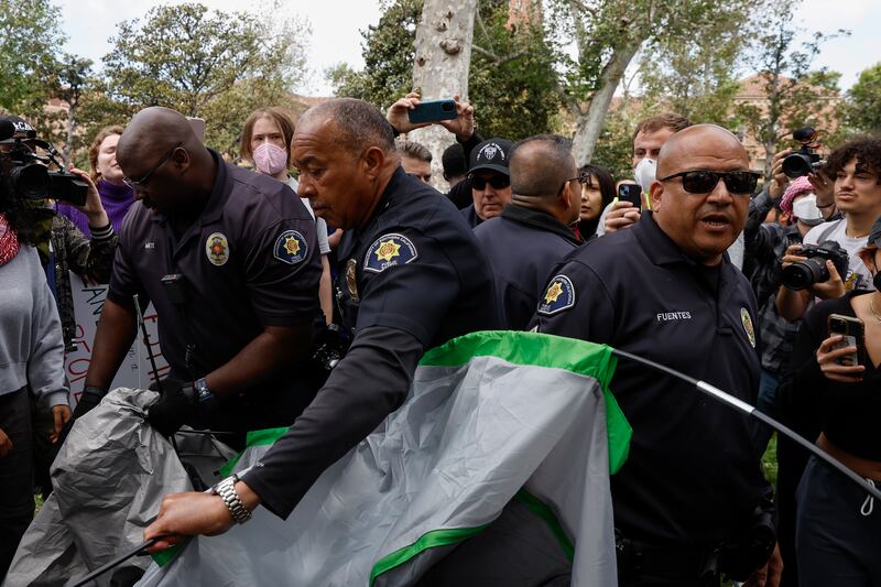 University of Southern California officers dismantle protesters' tents. EPA