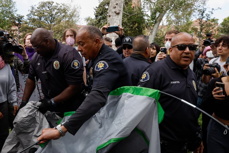 University of Southern California officers dismantle protesters' tents. EPA