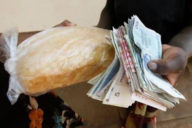 It took a lot of Zimbabwe dollar notes to buy a loaf of bread in September 2008. But in 2009 hyperinflation was eased by a reliance on the US greenback. Desmond Kwande / AFP