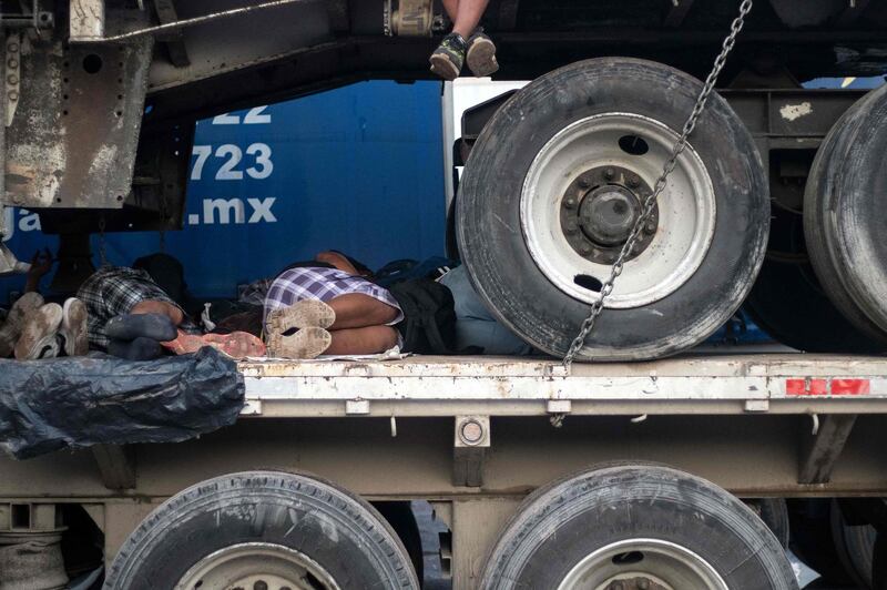 Migrants wait onboard a truck as the driver rests on the road linking Matias Romero and Donaji, Oaxaca State, Mexico. AFP