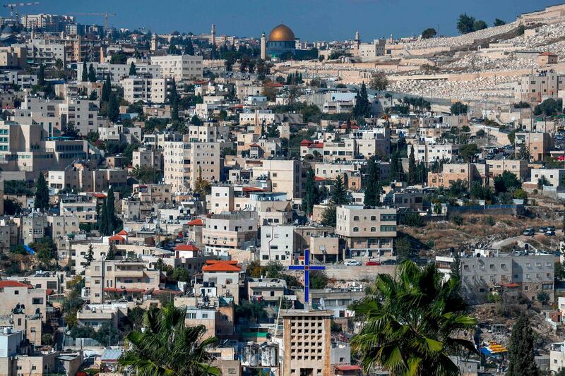 A picture taken from the West Bank town of Abu Dis, separated from Jerusalem by Israel's controversial barrier, shows the Dome of the Rock (top) in Jerusalem's al-Aqsa mosque compound and the Jewish cemetery of Mount of Olives (right). AFP