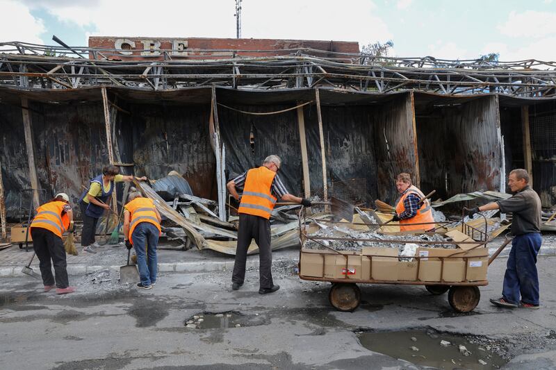 Municipal workers clean a street in Donetsk. Reuters 