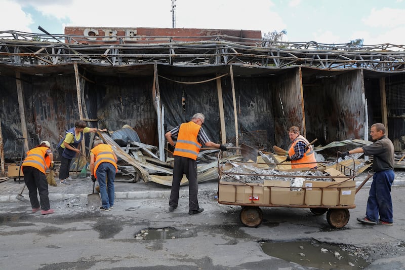 Municipal workers clean a street in Donetsk. Reuters 