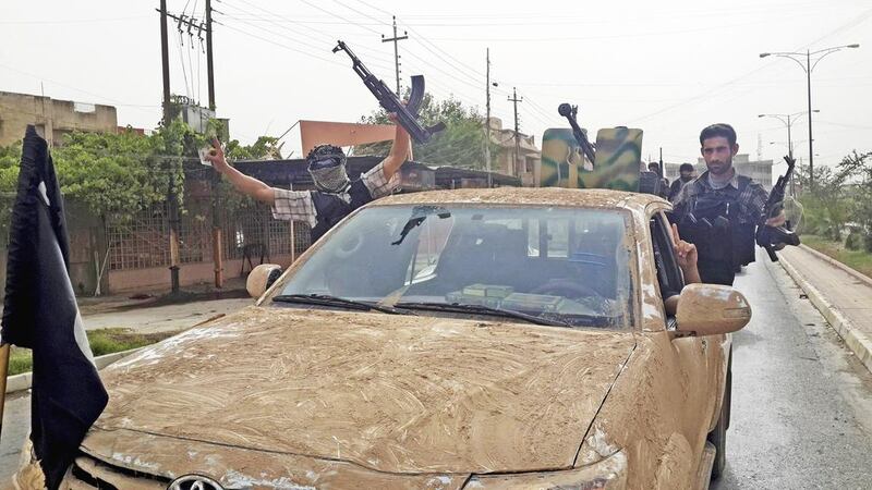 Fighters of the Islamic State of Iraq and the Levant celebrate in vehicles taken from Iraqi security forces in the northern city of Mosul. Reuters / June 12, 2014