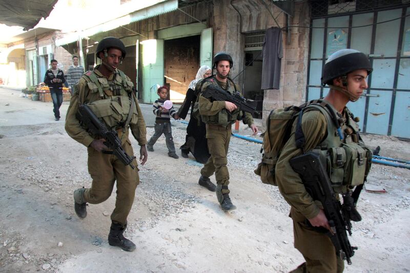 Israeli soldiers patrol the streets of downtown Hebron Saturday. Recent tensions between Israeli settlers and Palestinians have hurt trade in Hebron's old city (photo by Jamal Aruri)