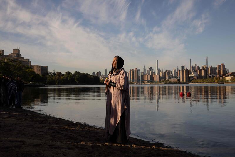 A woman prays during an Indigenous Peoples' Day sunrise ceremony on Randall's Island in New York City. The federal holiday to mark Columbus Day is also officially recognised as Indigenous Peoples' Day, following a proclamation by US President Joe Biden. AFP