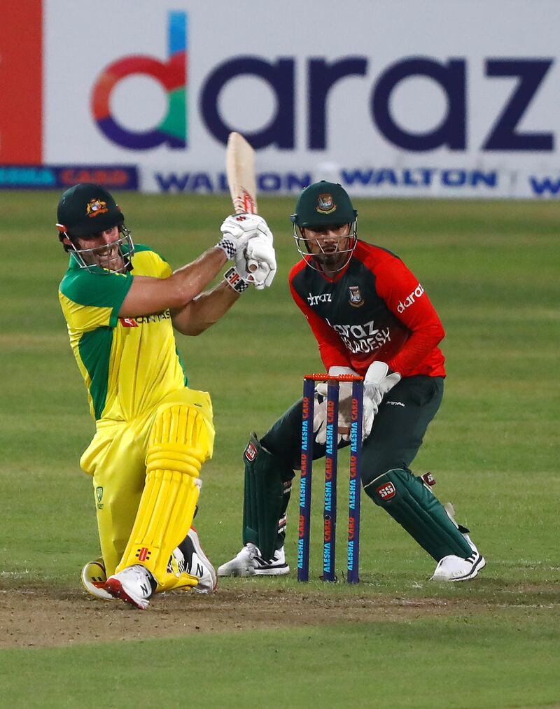 Australia's Mitchell Marsh plays a shot as Bangladesh's wicket-keeper Nurul Hasan looks on.