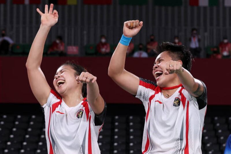 Greysia Polii and Apriyani Rahayu of Team Indonesia celebrate after winning the women's doubles in the badminton.